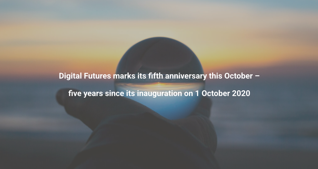 A hand holds a round object against a blurred sunset background. Text reads: Digital Futures marks its fifth anniversary this October – five years since its inauguration on 1 October 2020.