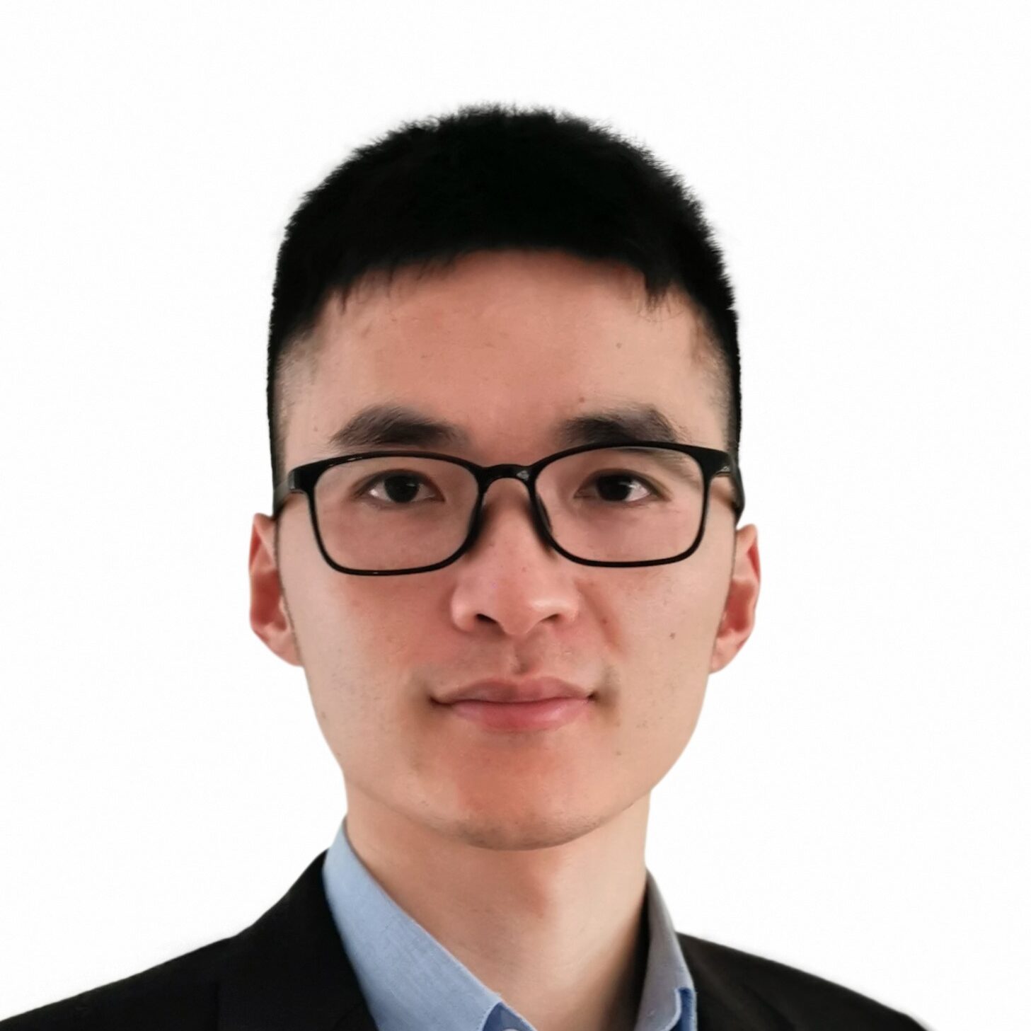 A young man with short black hair and glasses is wearing a blue collared shirt and a black blazer, standing against a plain white background.