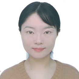 Portrait photo of a young woman with straight dark hair, wearing a light brown jumper and smiling softly, against a plain white background.