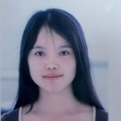 A young woman with long, straight black hair and a neutral expression faces the camera against a plain, light background.