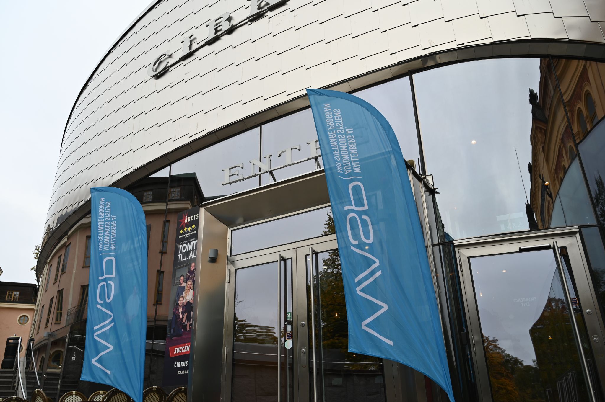 Entrance to Cirkus theatre featuring blue banners with the WASP logo and a poster for the show Årets Tomt till alla.