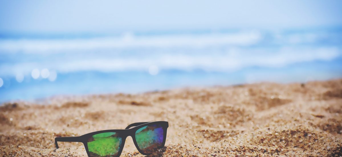 Picture of sunglasses on a beach from Unsplash